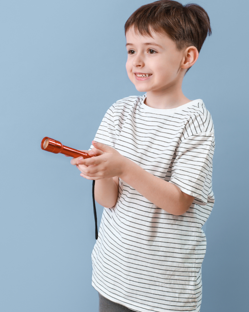 A young boy holding a flashlight