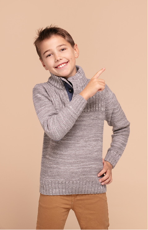 A happy child pointing upwards.