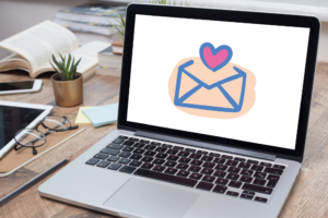 laptop displaying a graphic of an envelope and heart